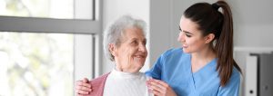 Medical Worker With Senior Woman In Nursing Home