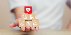 Health Insurance Concept,hand Arranging Wood Block Stacking With